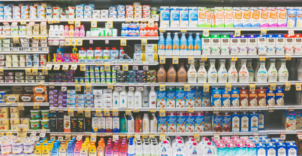 A wide variety of yogurts and milks at a grocery store.